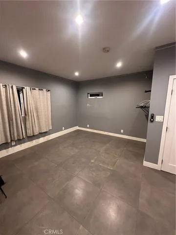 an empty room with a empty space and a ceiling fan