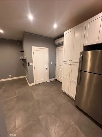 a view of a kitchen with a refrigerator and microwave