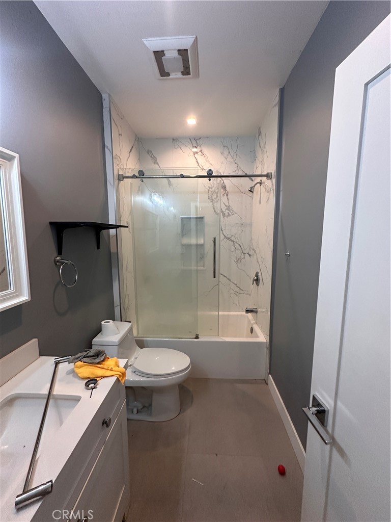 8963 Mercedes Avenue Arleta, CA 91331 - Photo 7 of 7 a bathroom with a granite countertop sink toilet and shower