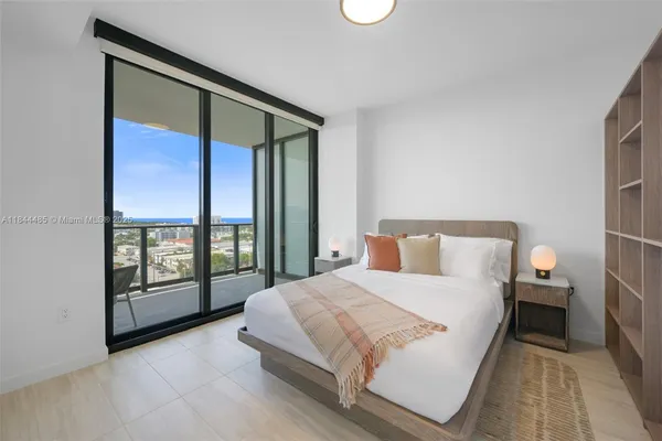 a bedroom with a large bed and a large window