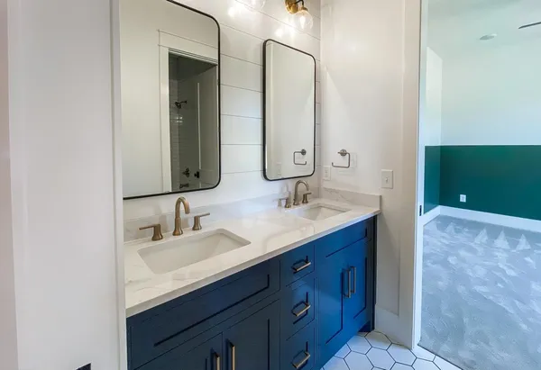 a bathroom with a double vanity sink and a mirror