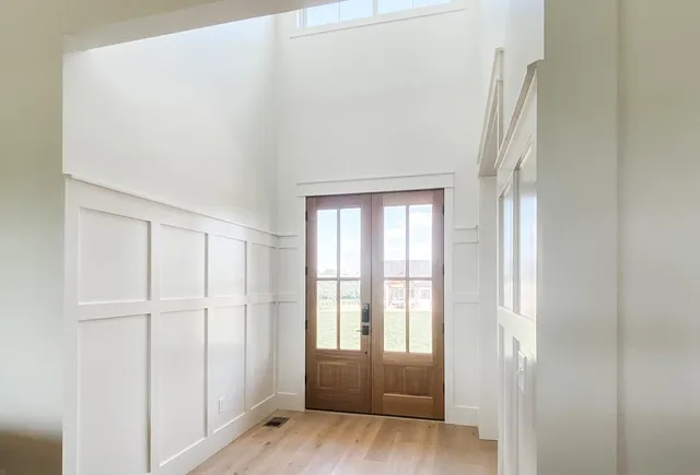 a view of wooden floor and windows in a room