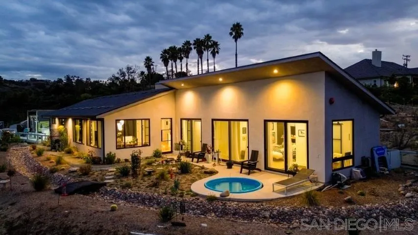 a swimming pool with outdoor seating yard and mountain view