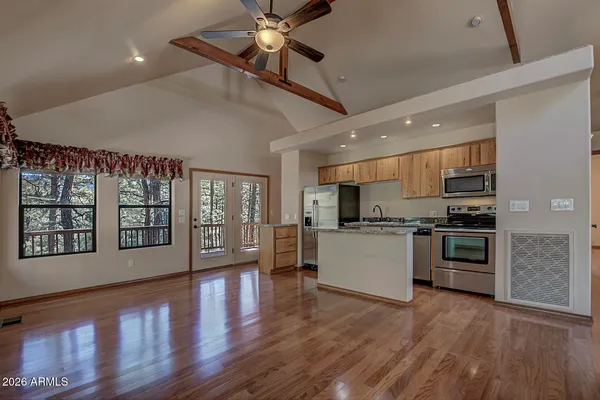 a kitchen with stainless steel appliances kitchen island wooden floors granite top and stainless steel appliances