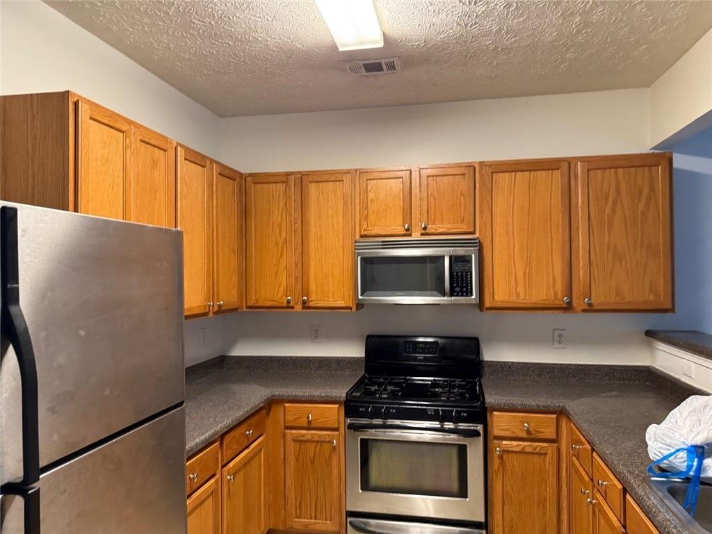 2502 Walden Lake Drive Decatur, GA 30035 - Photo 5 of 8 a kitchen with granite countertop cabinets stainless steel appliances and a counter space
