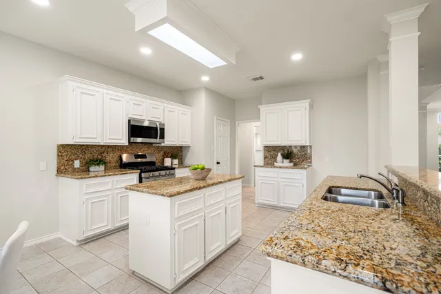 a kitchen with a sink stove and microwave