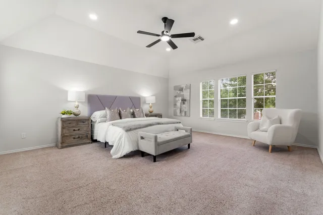 a bedroom with a bed and a couch