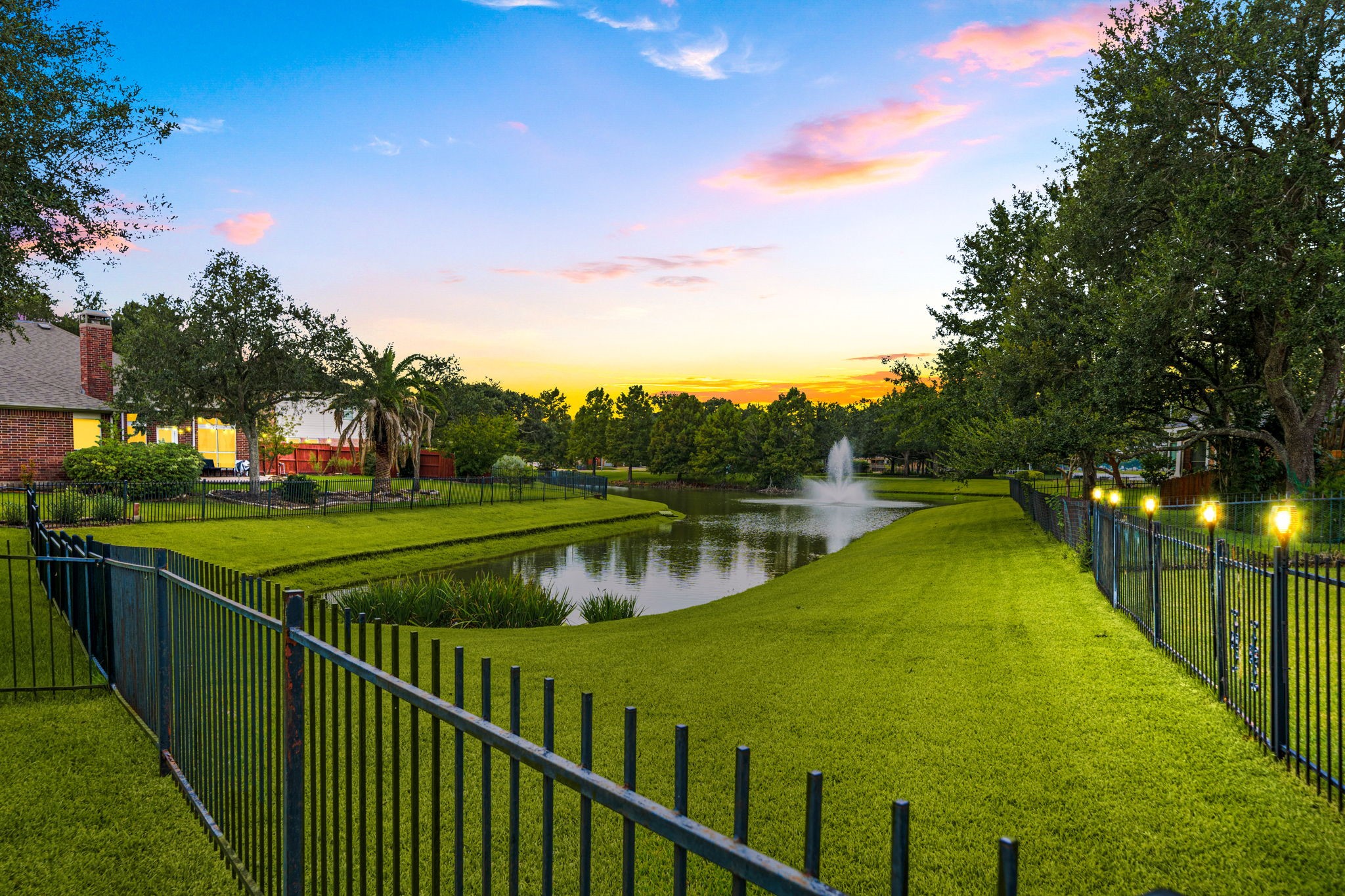 22 Crestview Trail Houston, TX 77082 - Photo 2 of 39 a view of a lake with a wooden bridge