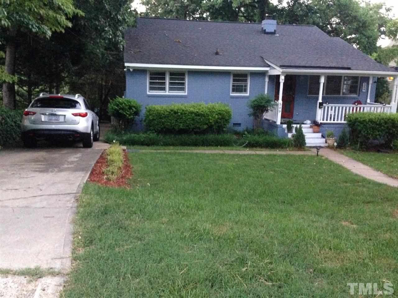 309 Avon Drive Raleigh, NC 27608 - Photo 1 of 17 a front view of a house with a garden and trees