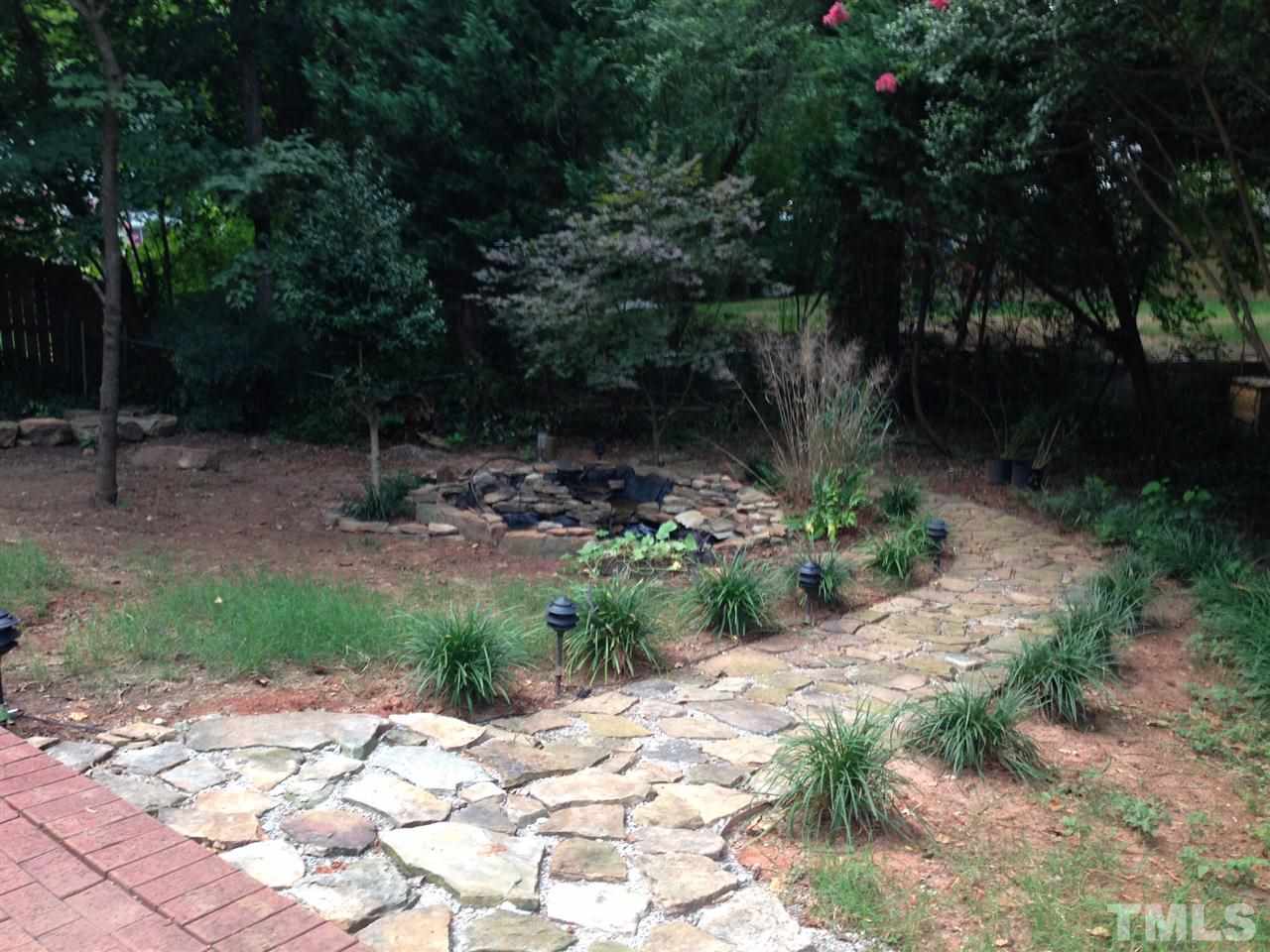 309 Avon Drive Raleigh, NC 27608 - Photo 16 of 17 a backyard of a house with lots of green space