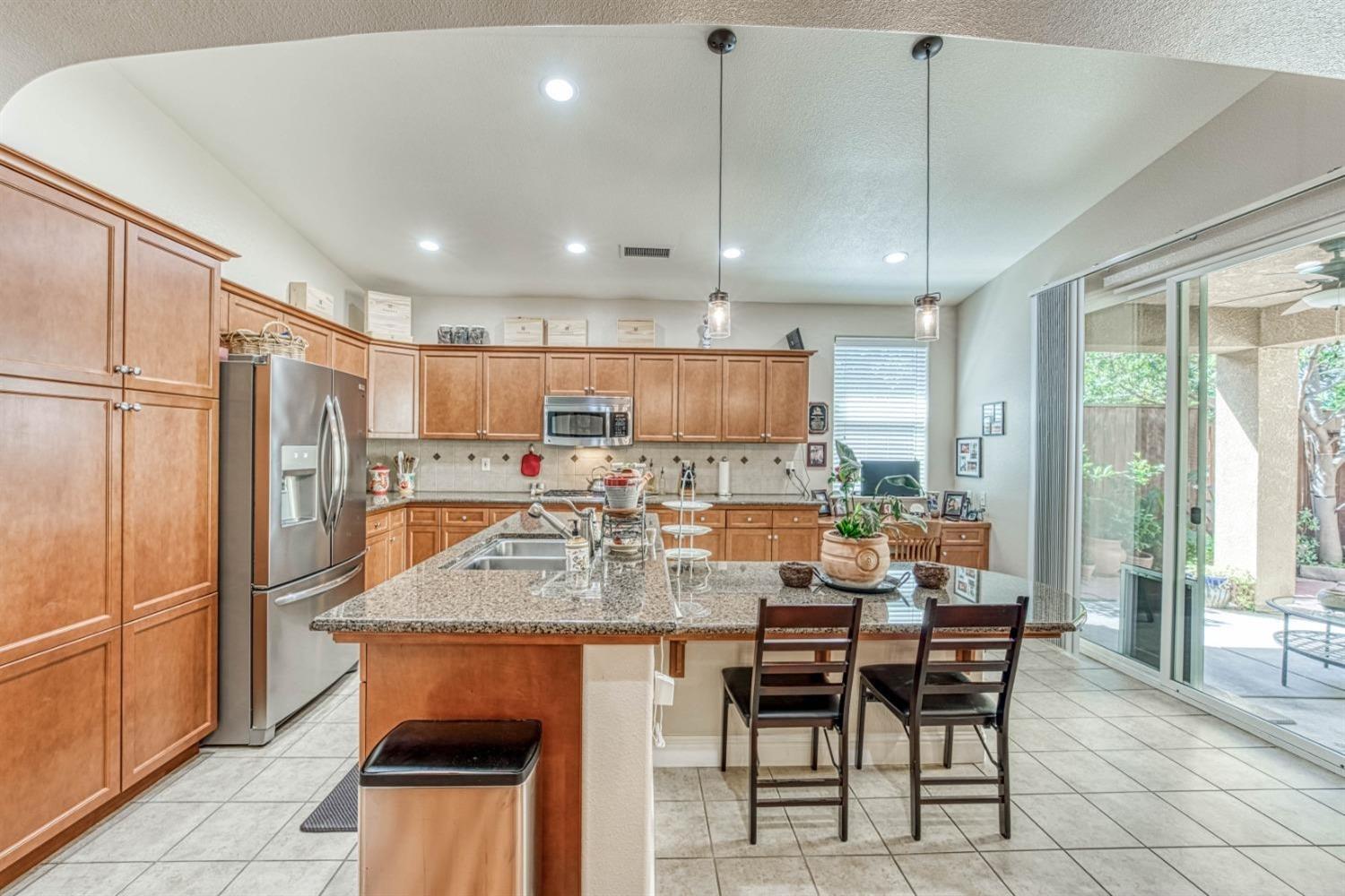 3754 Salem Lane Clovis, CA 93619 - Photo 6 of 18 a view of a dining room and kitchen with a table chairs