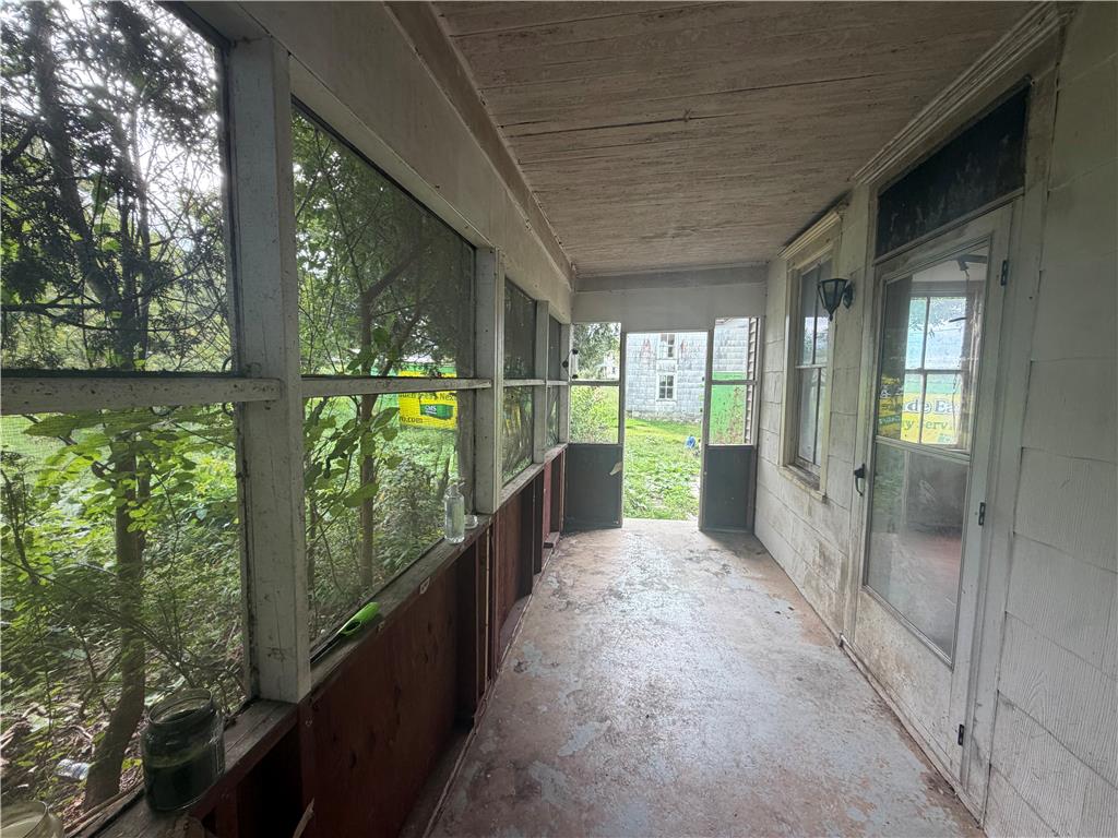 8745 Ashfield Road Slatington, PA 18080 - Photo 6 of 17 A long screened porch overlooks the surrounding greenery and yard.