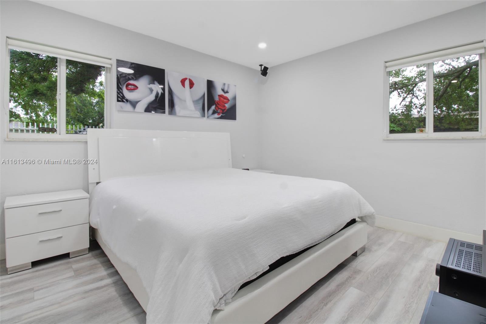9730 Southwest 76th Street Miami, FL 33173 - Photo 11 of 27 a bedroom with a bed and a large window