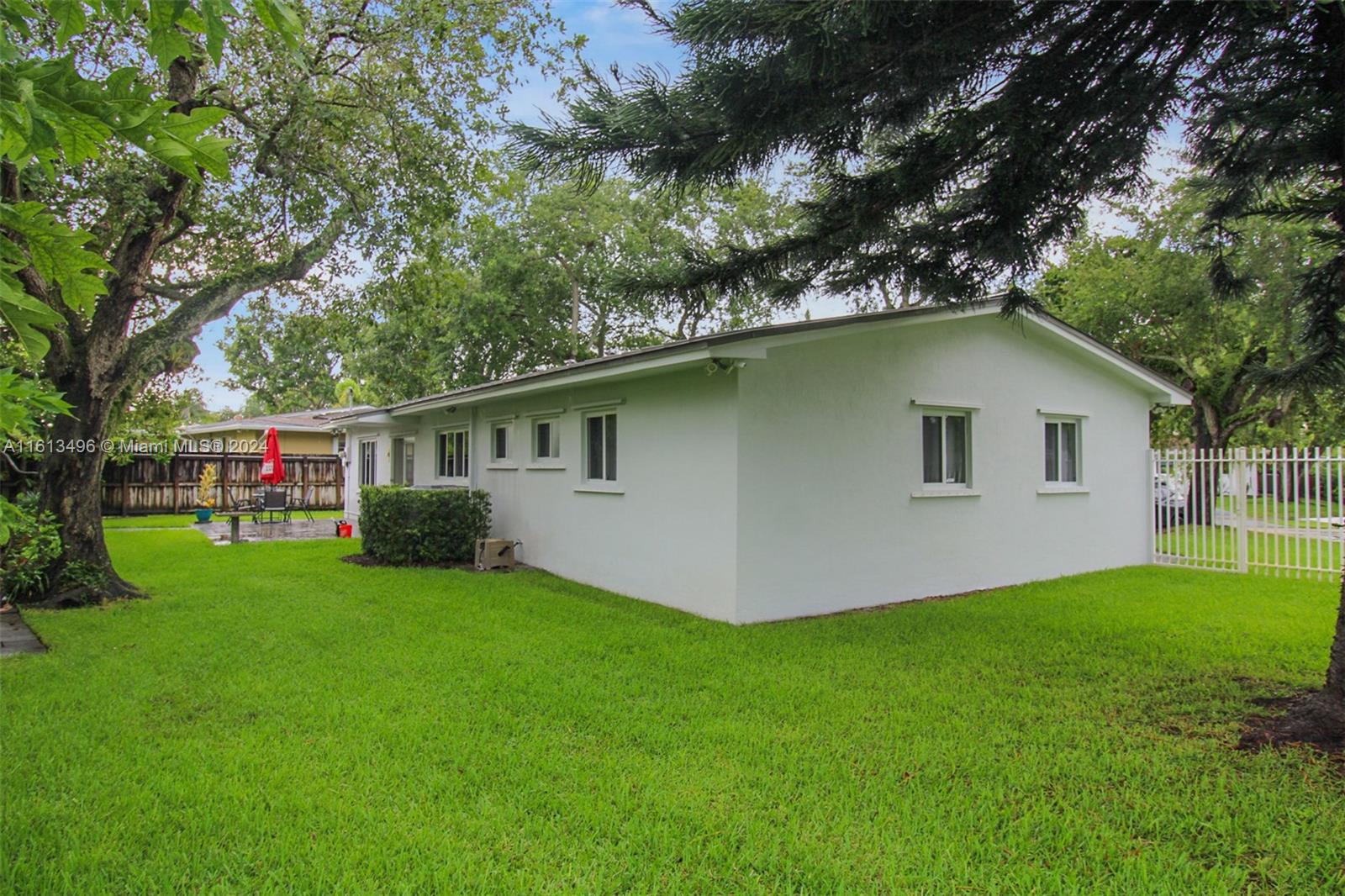 9730 Southwest 76th Street Miami, FL 33173 - Photo 16 of 27 a front view of house with yard and green space