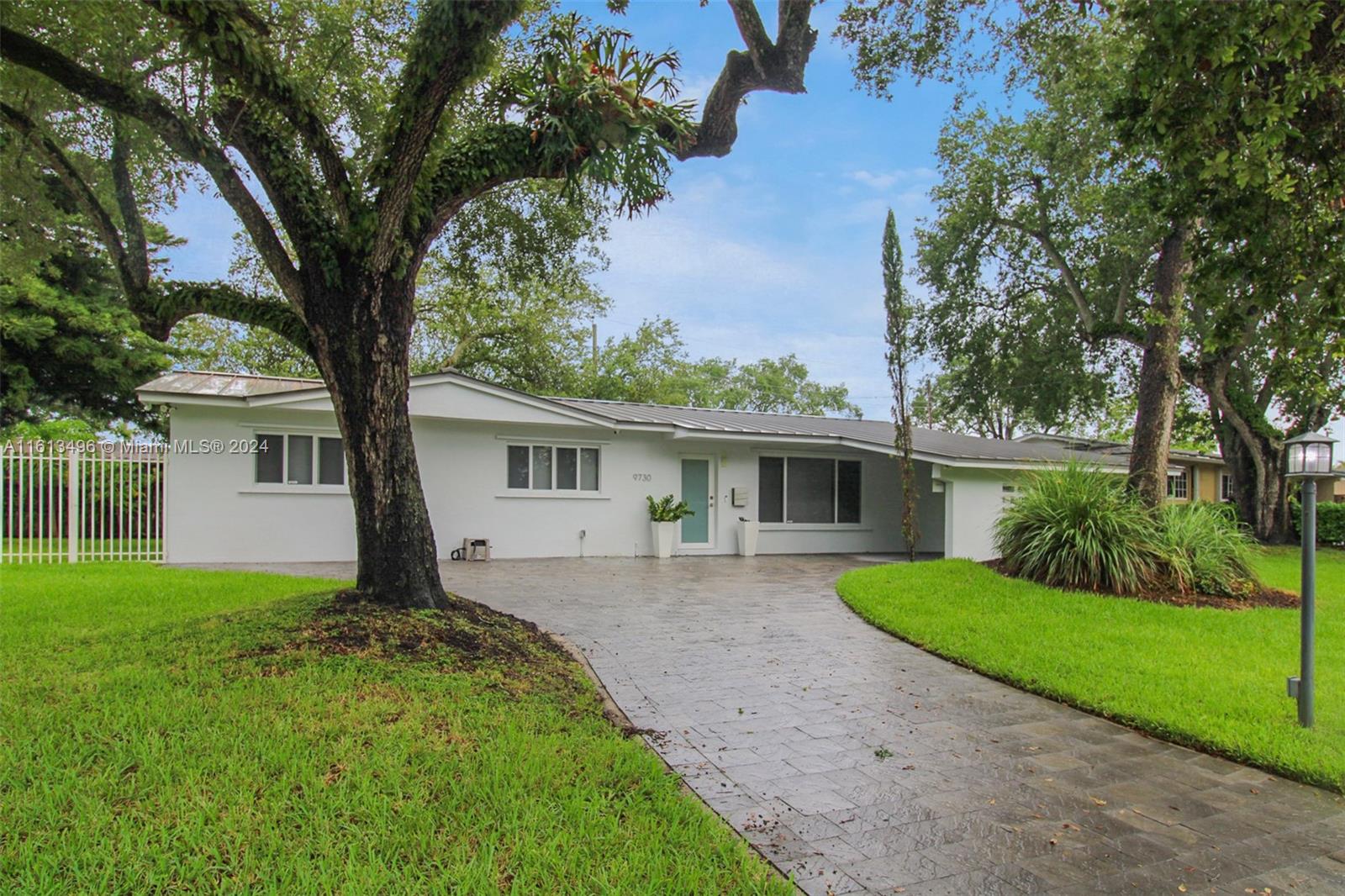 9730 Southwest 76th Street Miami, FL 33173 - Photo 19 of 27 front view of a house with a yard