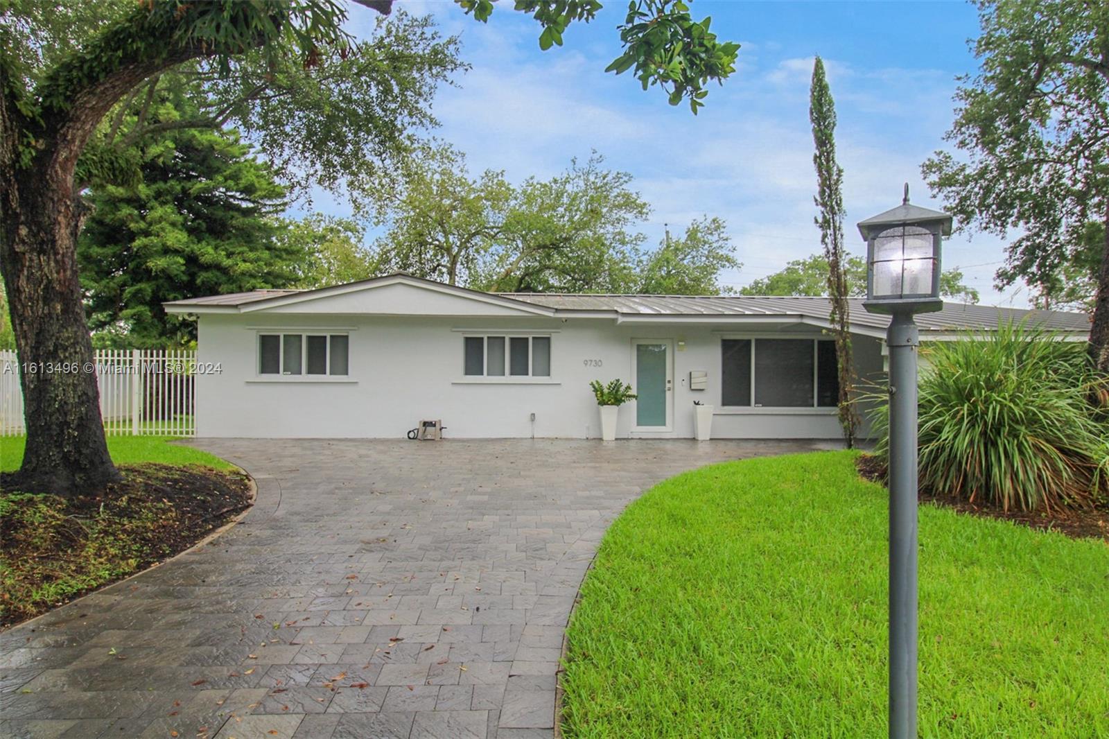 9730 Southwest 76th Street Miami, FL 33173 - Photo 20 of 27 a front view of house with a garden