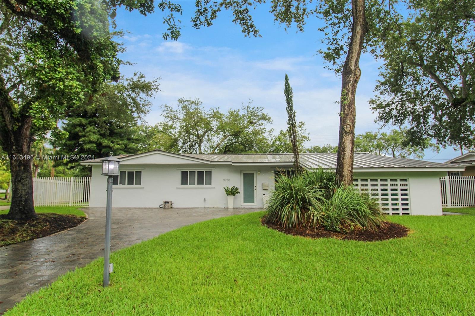 9730 Southwest 76th Street Miami, FL 33173 - Photo 22 of 27 a view of a house with a yard