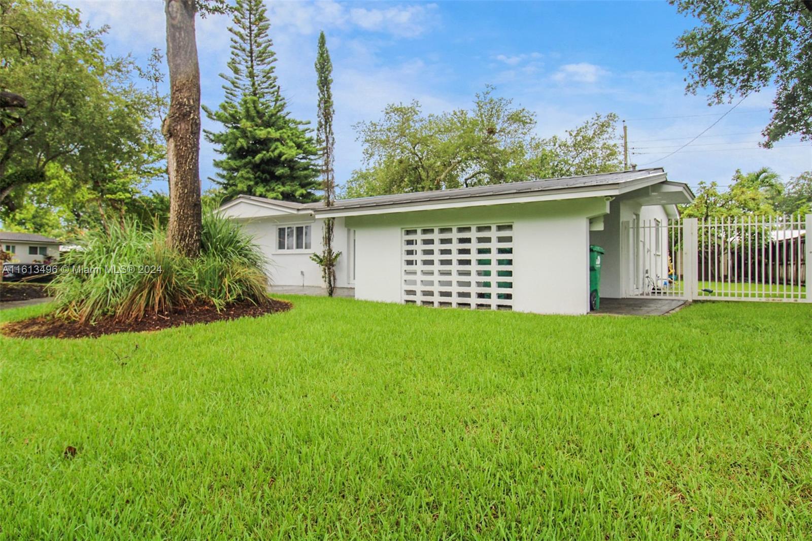 9730 Southwest 76th Street Miami, FL 33173 - Photo 23 of 27 front view of a house with a garden
