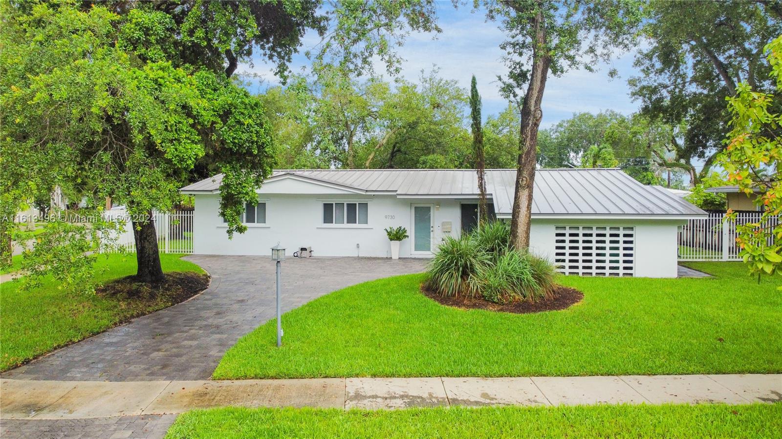 9730 Southwest 76th Street Miami, FL 33173 - Photo 24 of 27 a view of a house with a yard