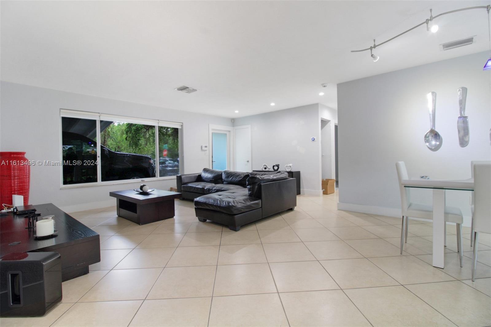 9730 Southwest 76th Street Miami, FL 33173 - Photo 3 of 27 a living room with furniture and a large window