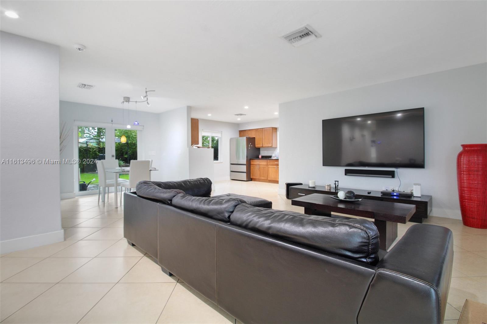 9730 Southwest 76th Street Miami, FL 33173 - Photo 5 of 27 a living room with furniture and a flat screen tv