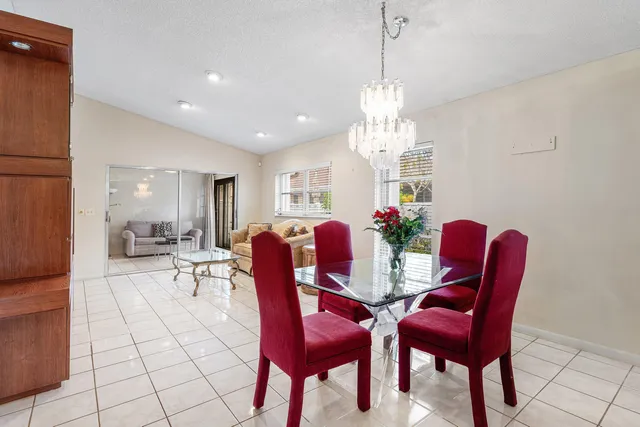a view of a dining room with furniture and chandelier