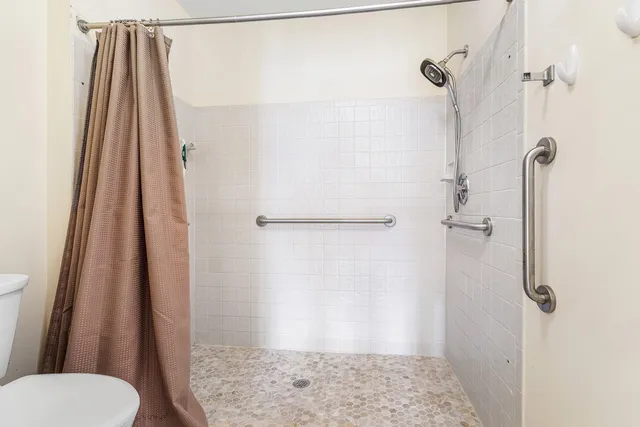 a living room with furniture and a floor to ceiling window