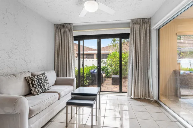 a living room with furniture and a floor to ceiling window