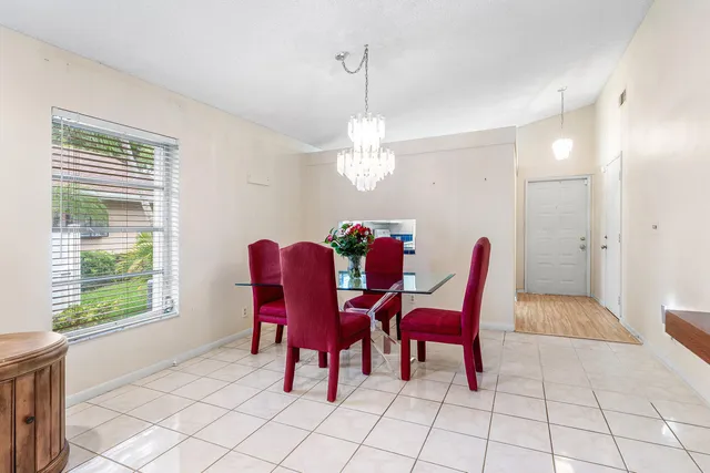 a view of a dining room with furniture and chandelier