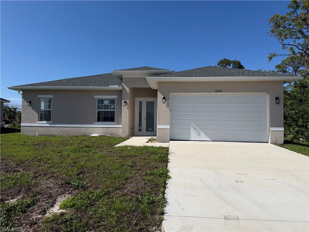 3310 11th Street West Lehigh Acres, FL 33971 - Photo 1 of 20 a front view of a house with garden