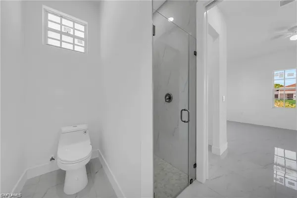 a bathroom with a toilet sink and shower