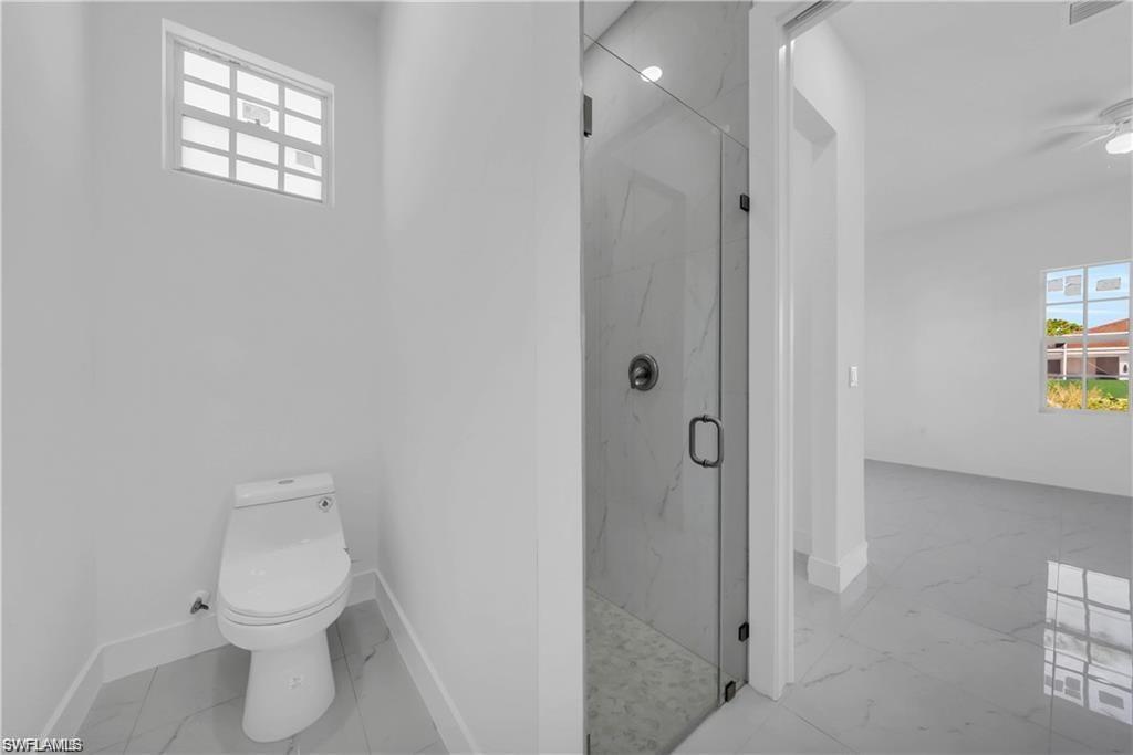 3310 11th Street West Lehigh Acres, FL 33971 - Photo 16 of 20 a bathroom with a toilet sink and shower