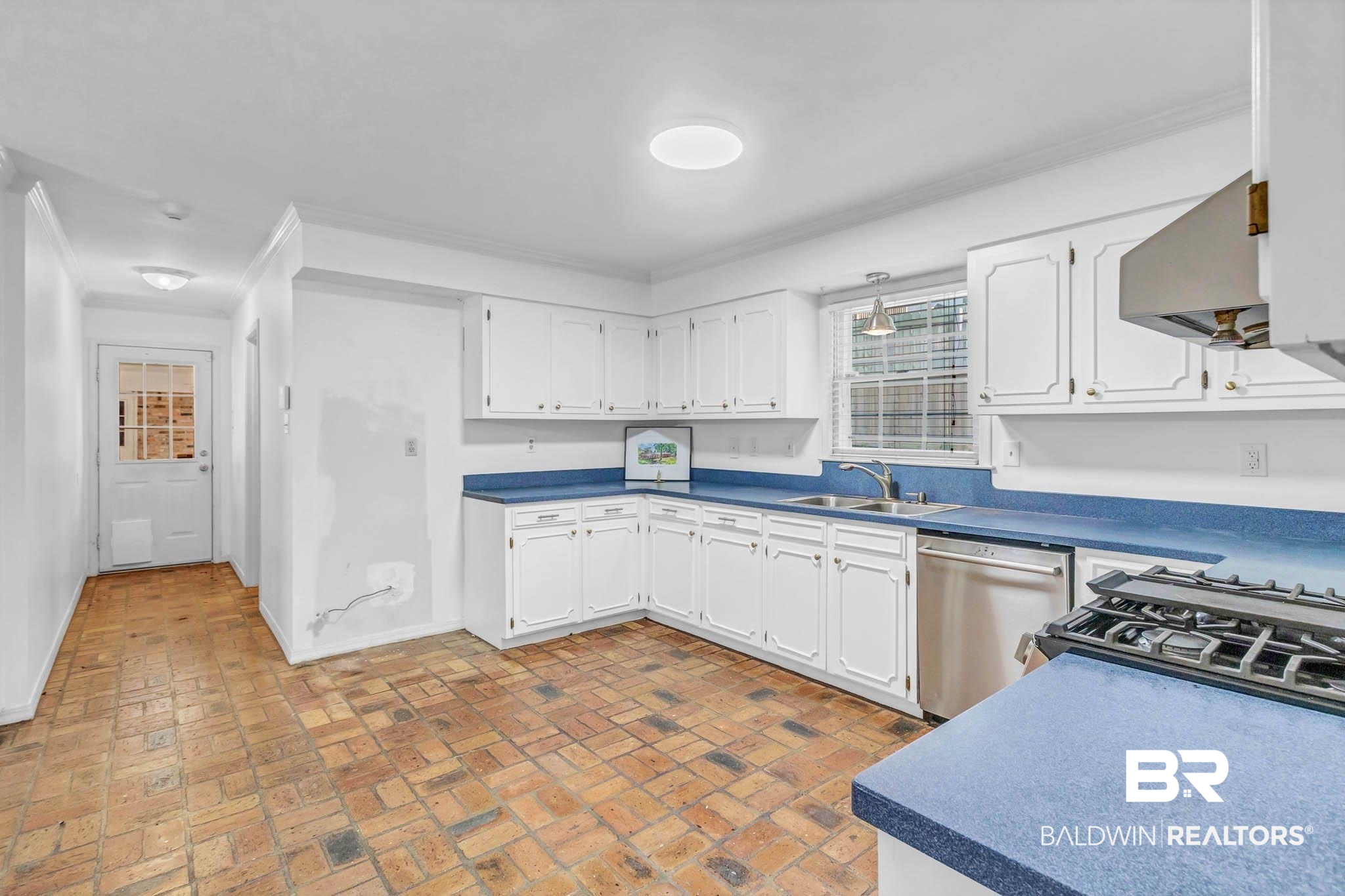 309 West Brandy Run Road Mobile, AL 36608 - Photo 18 of 100 Kitchen featuring white cabinets, brick floors, dishwasher, wall chimney exhaust hood, and crown molding