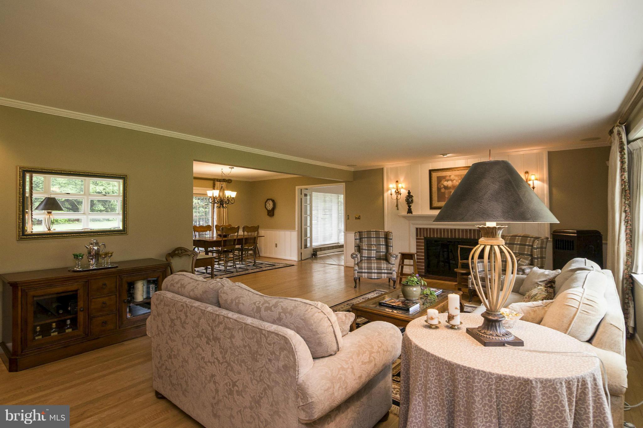 1200 Doves Cove Road Baltimore, MD 21286 - Photo 2 of 25 a living room with fireplace furniture and a flat screen tv