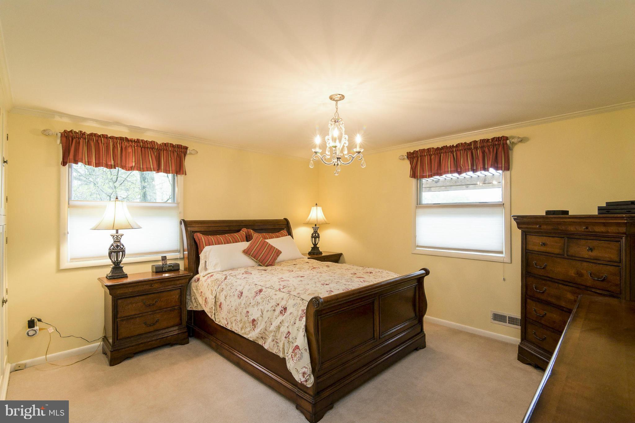 1200 Doves Cove Road Baltimore, MD 21286 - Photo 11 of 25 a bedroom with a bed and dresser with mirror
