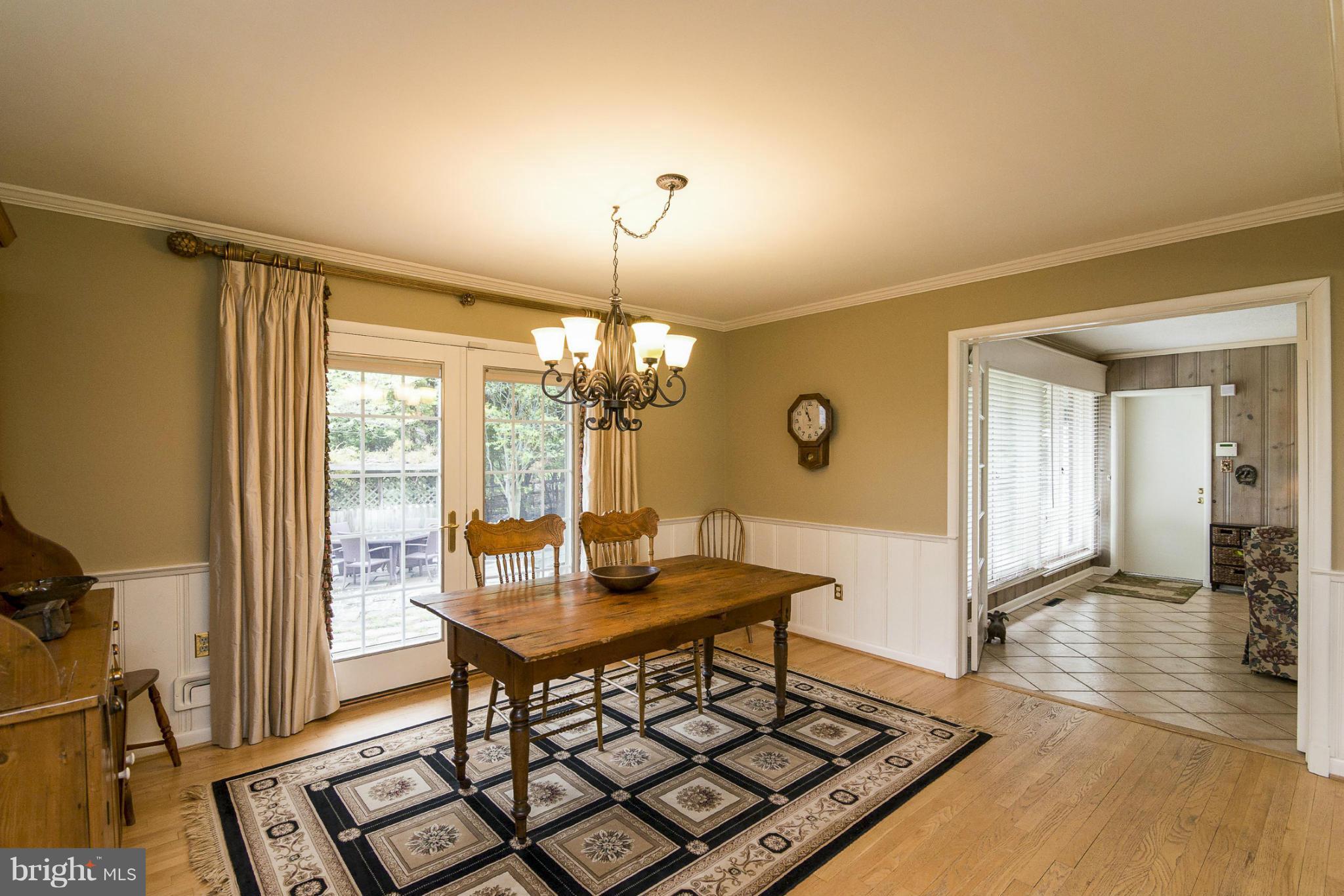 1200 Doves Cove Road Baltimore, MD 21286 - Photo 4 of 25 a view of a dining room with furniture and wooden floor