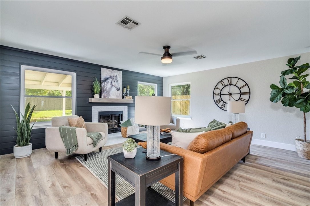 1702 Blue Bell Drive Cedar Park, TX 78613 - Photo 1 of 1 a living room with furniture a fireplace and a large window