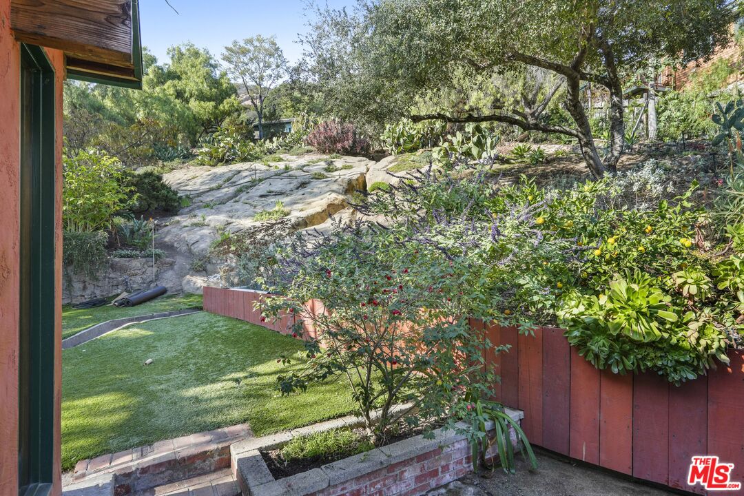 809 Basin Drive Topanga, CA 90290 - Photo 11 of 57 a view of a yard with plants and wooden fence
