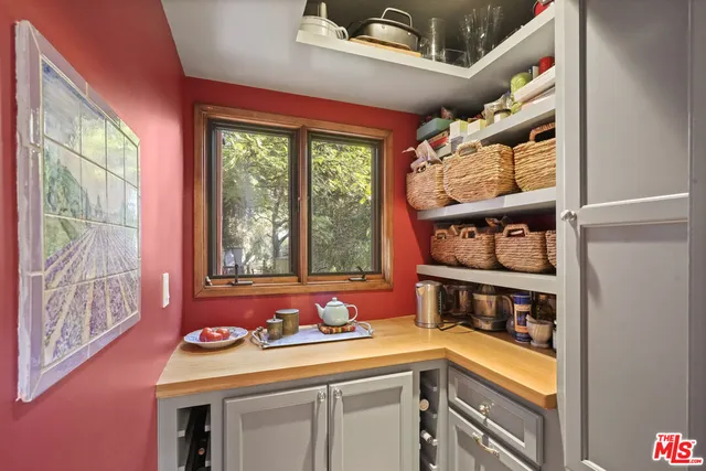 a living room with furniture and large windows