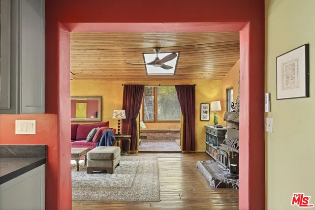 a living room with couch and floor to ceiling windows