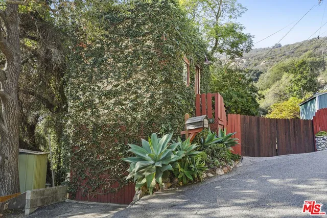 a living room with furniture and a book shelf