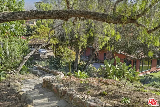 a backyard of a house with a yard and outdoor seating