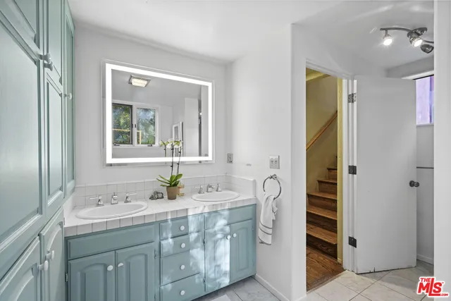 a white toilet sitting next to a bathroom sink