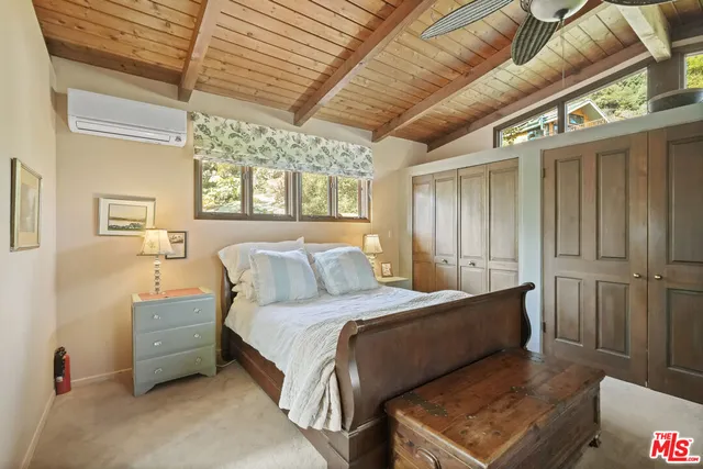 a bathroom with a granite countertop sink a toilet and a mirror
