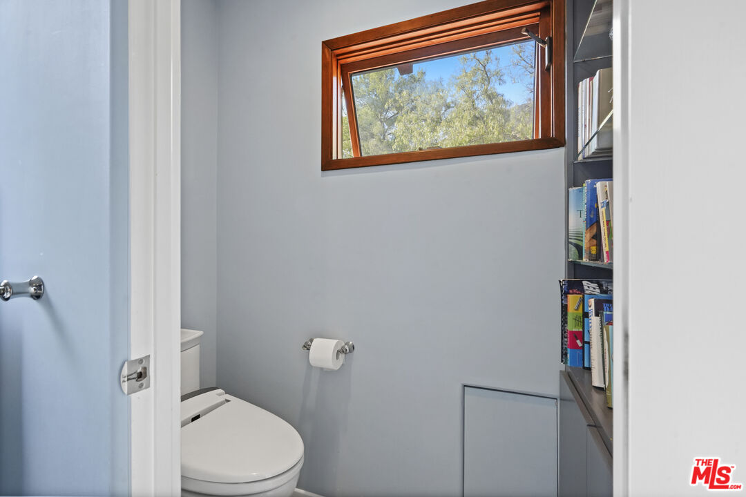 809 Basin Drive Topanga, CA 90290 - Photo 53 of 57 a white toilet sitting next to a bathroom sink
