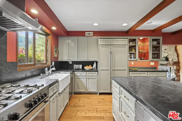 a vase of flowers sitting on a window sill and a window
