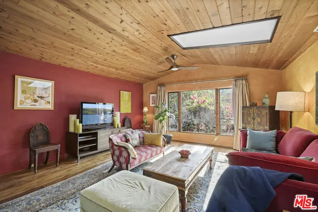 a front view of a house with plants