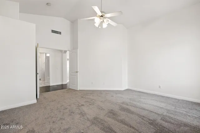 a view of a kitchen with wooden floor and a ceiling fan