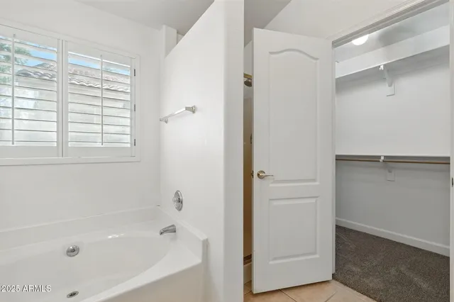 an empty room with chandelier fan