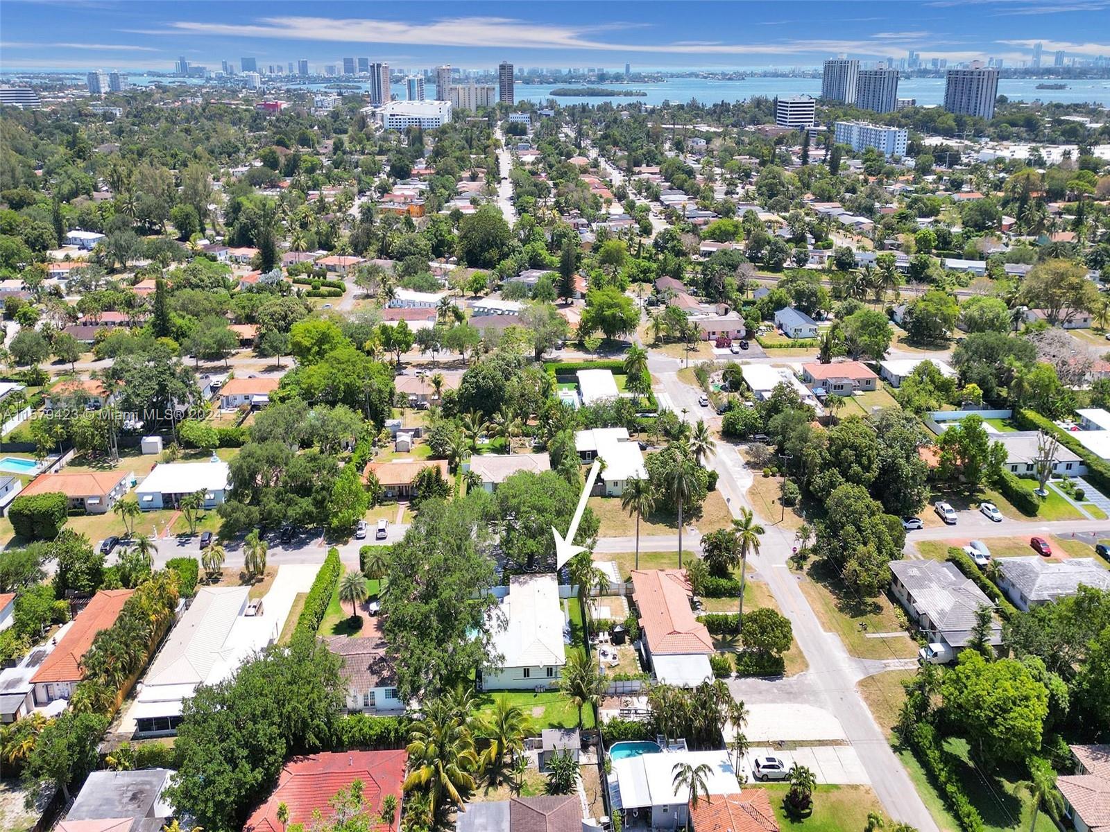 an aerial view of residential houses with city view